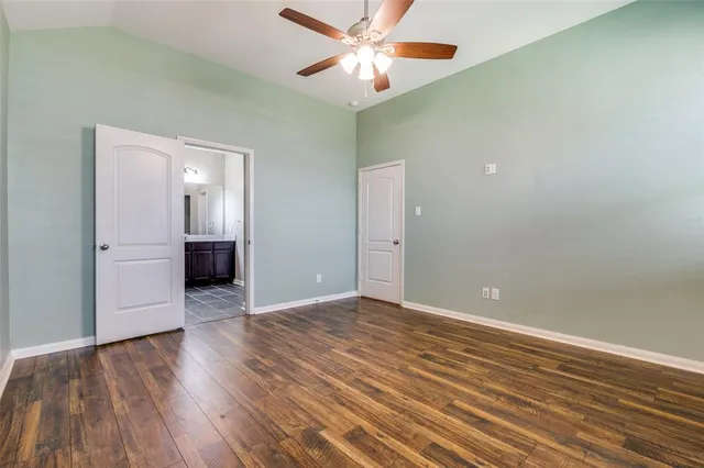 a bedroom with a bed and a potted plant