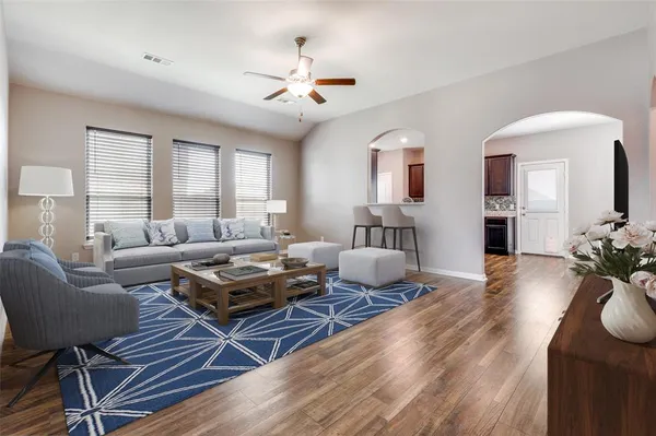 a living room with furniture and wooden floor
