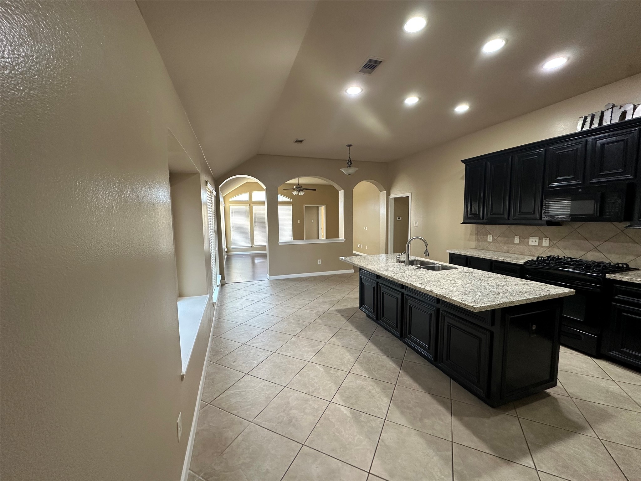 27511 Gatlin Lane Spring, TX 77386 - Photo 5 of 18 Open and inviting view showcasing the modern kitchen flowing into the hallway and living area, highlighting space