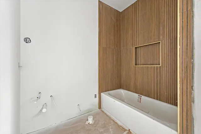 a bathroom with a bathtub and a shower