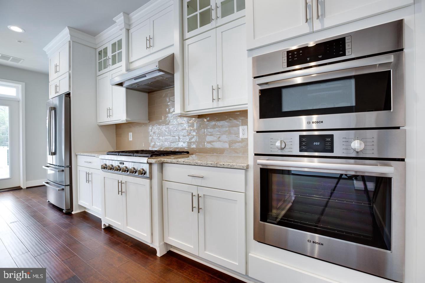 1979 Roland Clarke Place Reston, VA 20191 - Photo 12 of 52 a kitchen with stainless steel appliances white cabinets and stove