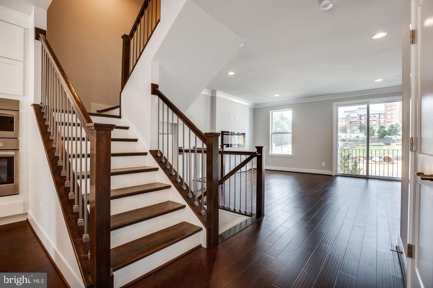 1979 Roland Clarke Place Reston, VA 20191 - Photo 14 of 52 a view of staircase with wooden floor and stairs