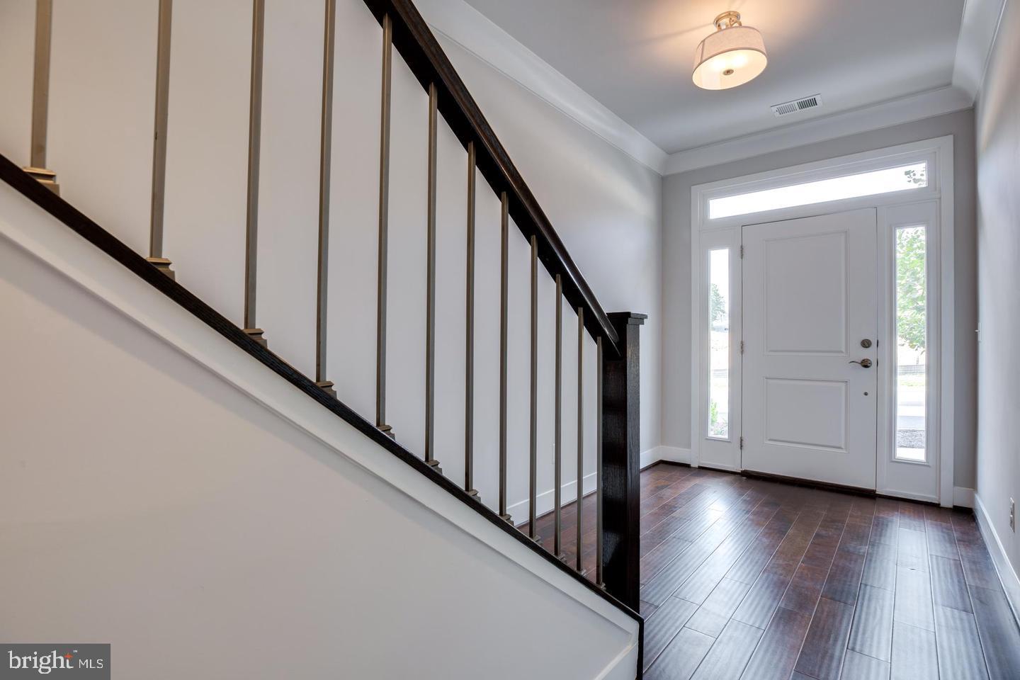 1979 Roland Clarke Place Reston, VA 20191 - Photo 19 of 52 a view of a hallway with wooden floor and staircase