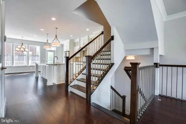 a view of staircase with wooden floor and a window