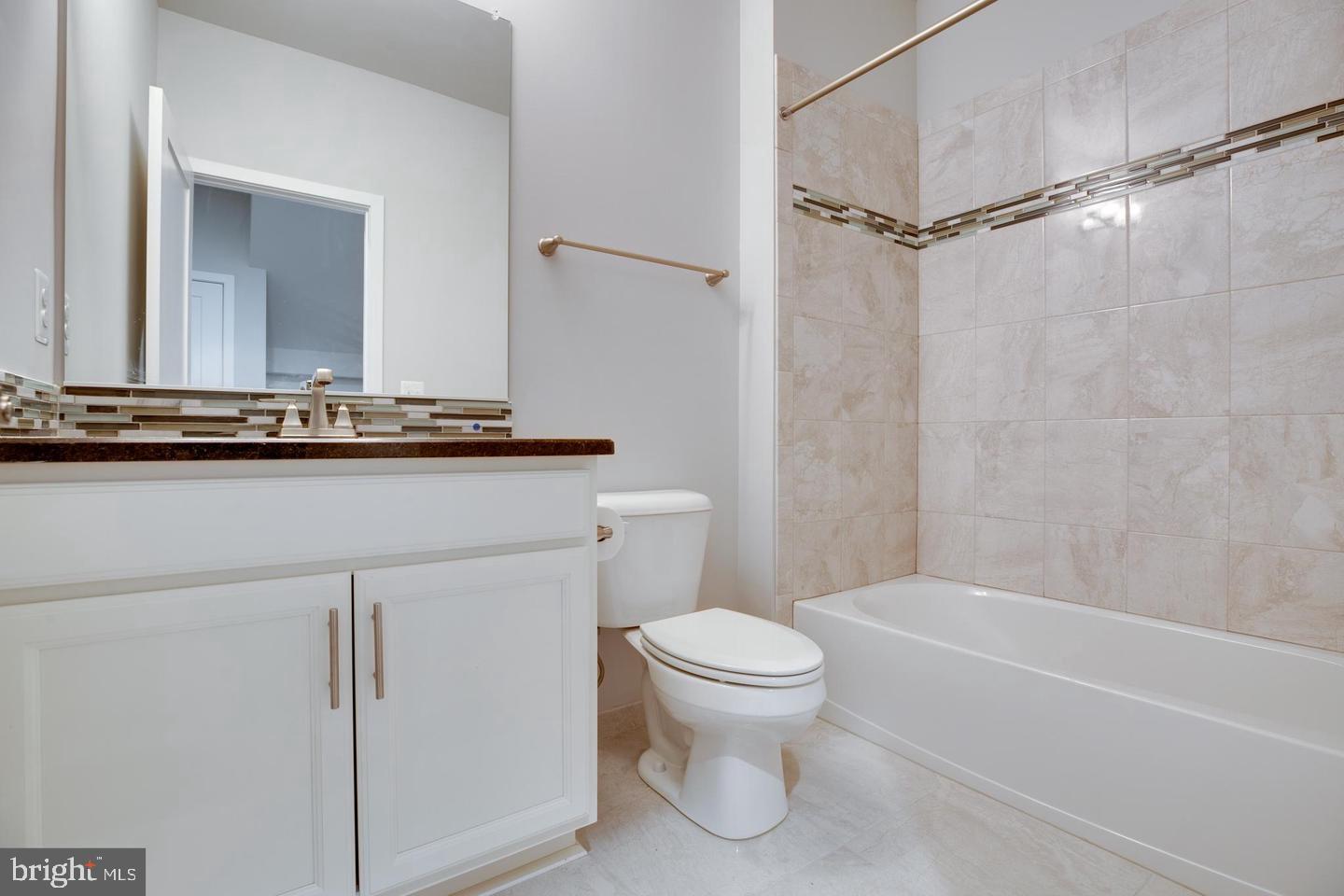 1979 Roland Clarke Place Reston, VA 20191 - Photo 33 of 52 a bathroom with a granite countertop sink mirror vanity and toilet