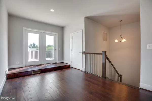 a view of a livingroom with wooden floor and window