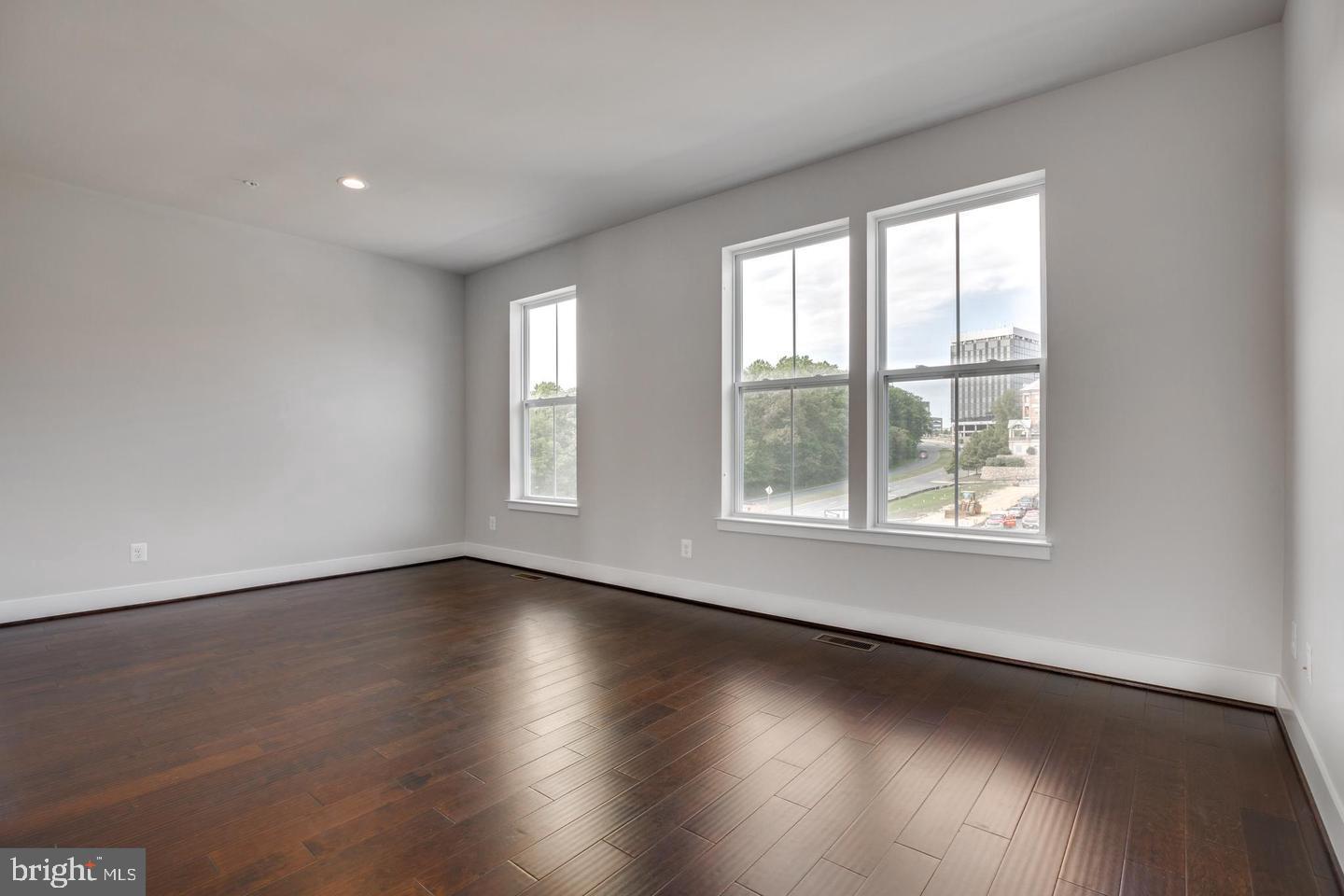 1979 Roland Clarke Place Reston, VA 20191 - Photo 38 of 52 an empty room with wooden floor and windows