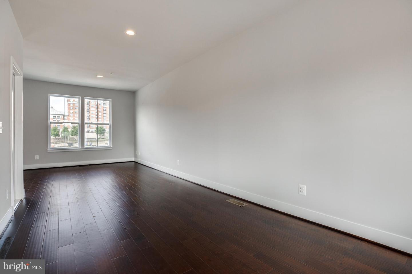 1979 Roland Clarke Place Reston, VA 20191 - Photo 40 of 52 an empty room with wooden floor and windows