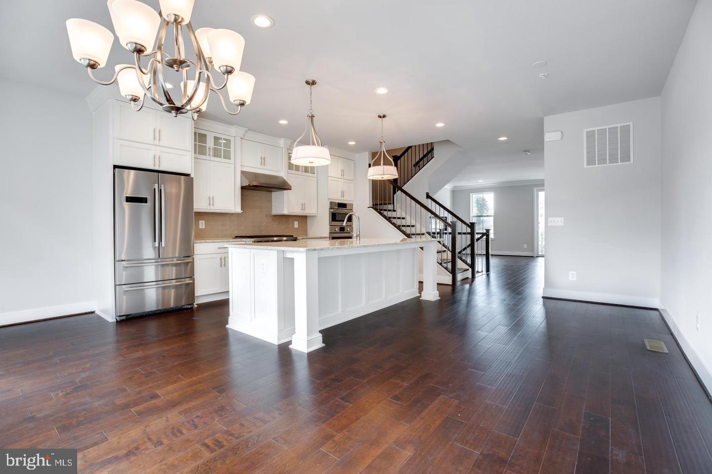 1979 Roland Clarke Place Reston, VA 20191 - Photo 5 of 52 a view of a kitchen with granite countertop wooden floor and a chandelier