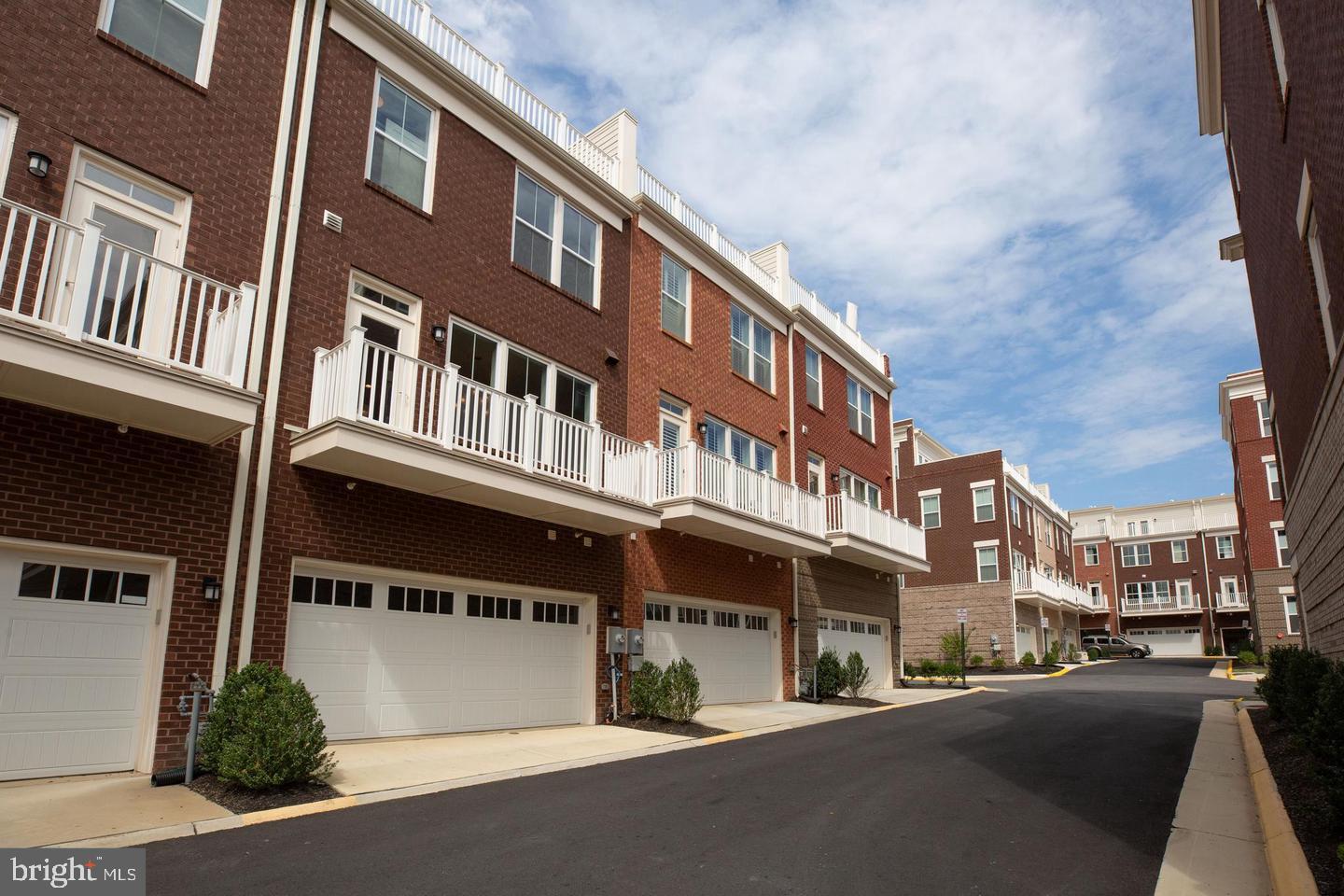 1979 Roland Clarke Place Reston, VA 20191 - Photo 51 of 52 a front view of a building with lot of cars and trees