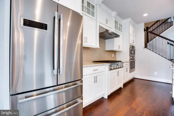 a kitchen with stainless steel appliances a refrigerator sink and cabinets