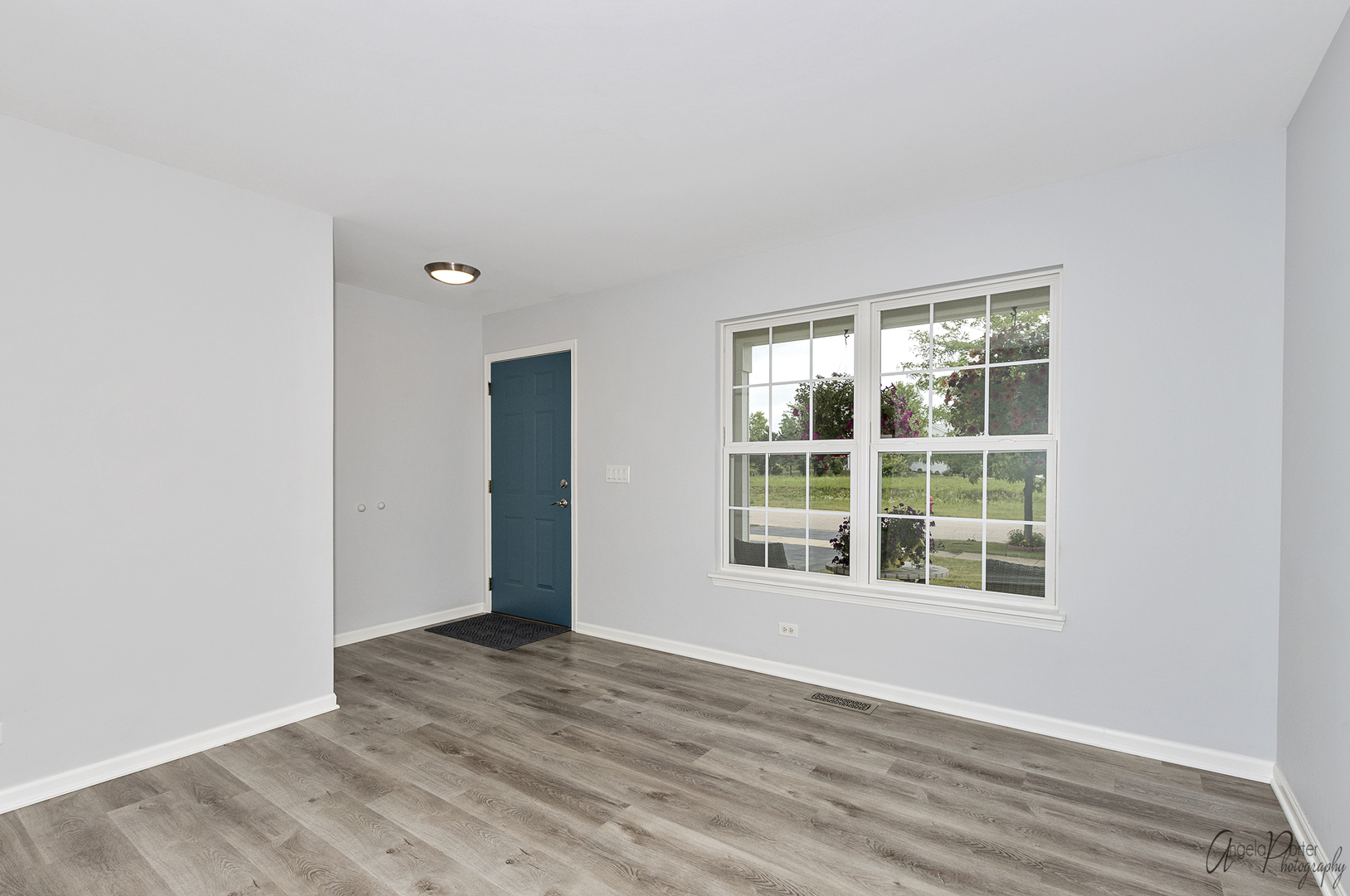 4801 Stillwater Road Wonder Lake, IL 60097 - Photo 13 of 36 an empty room with wooden floor and windows