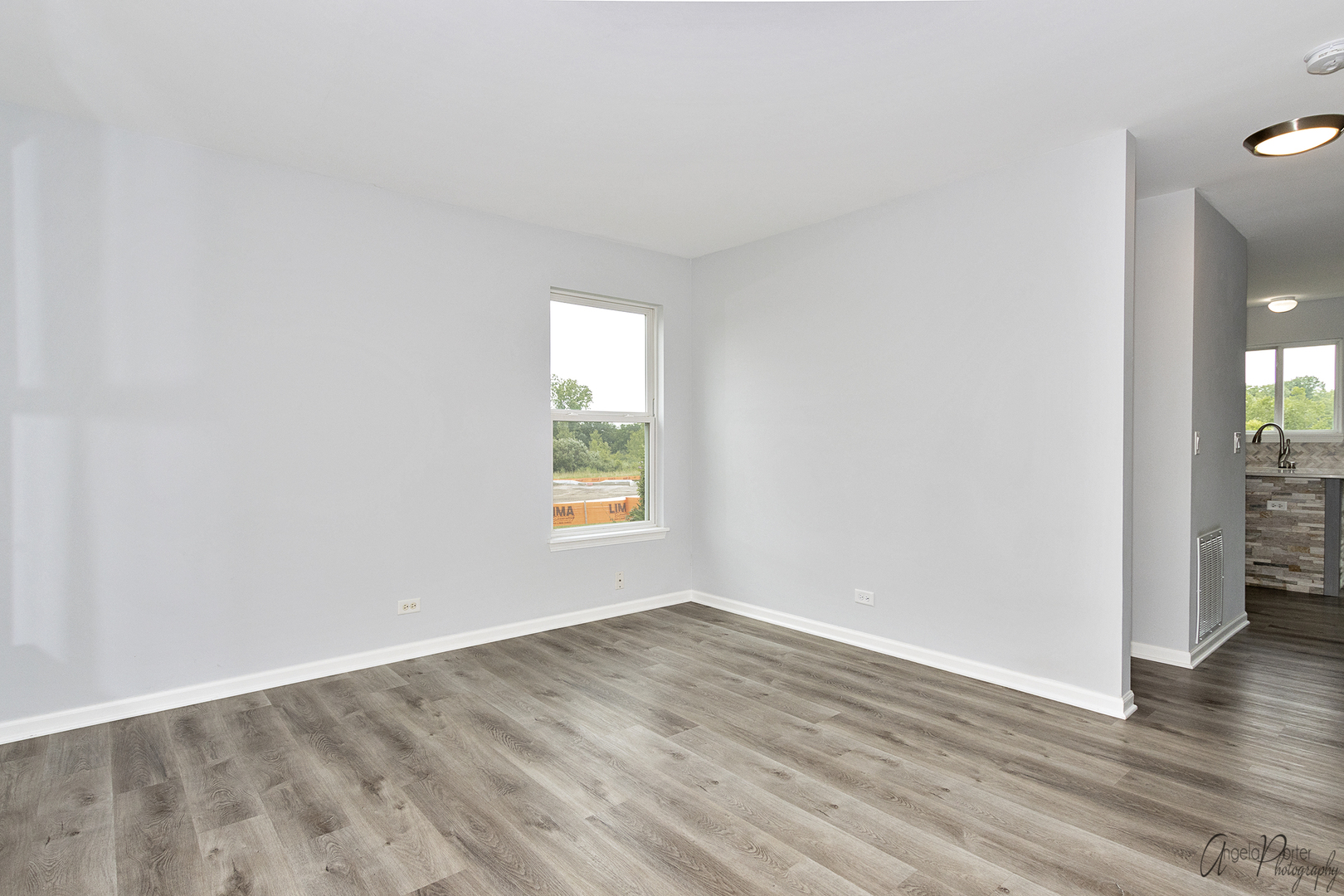 4801 Stillwater Road Wonder Lake, IL 60097 - Photo 15 of 36 an empty room with wooden floor and a window