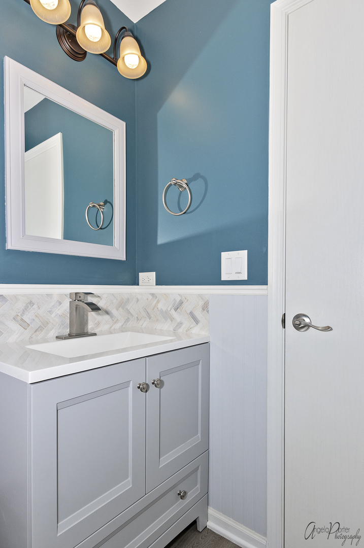 4801 Stillwater Road Wonder Lake, IL 60097 - Photo 16 of 36 a bathroom with a granite countertop sink a toilet and a mirror