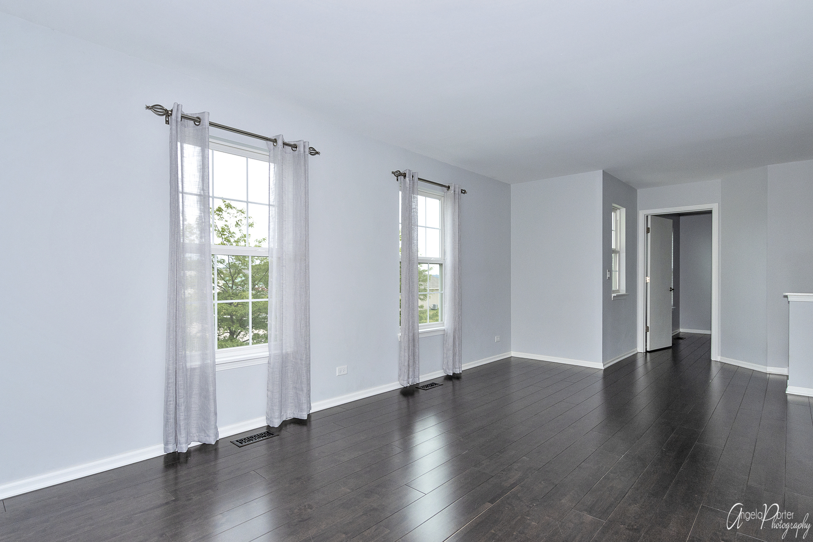 4801 Stillwater Road Wonder Lake, IL 60097 - Photo 23 of 36 an empty room with wooden floor and windows