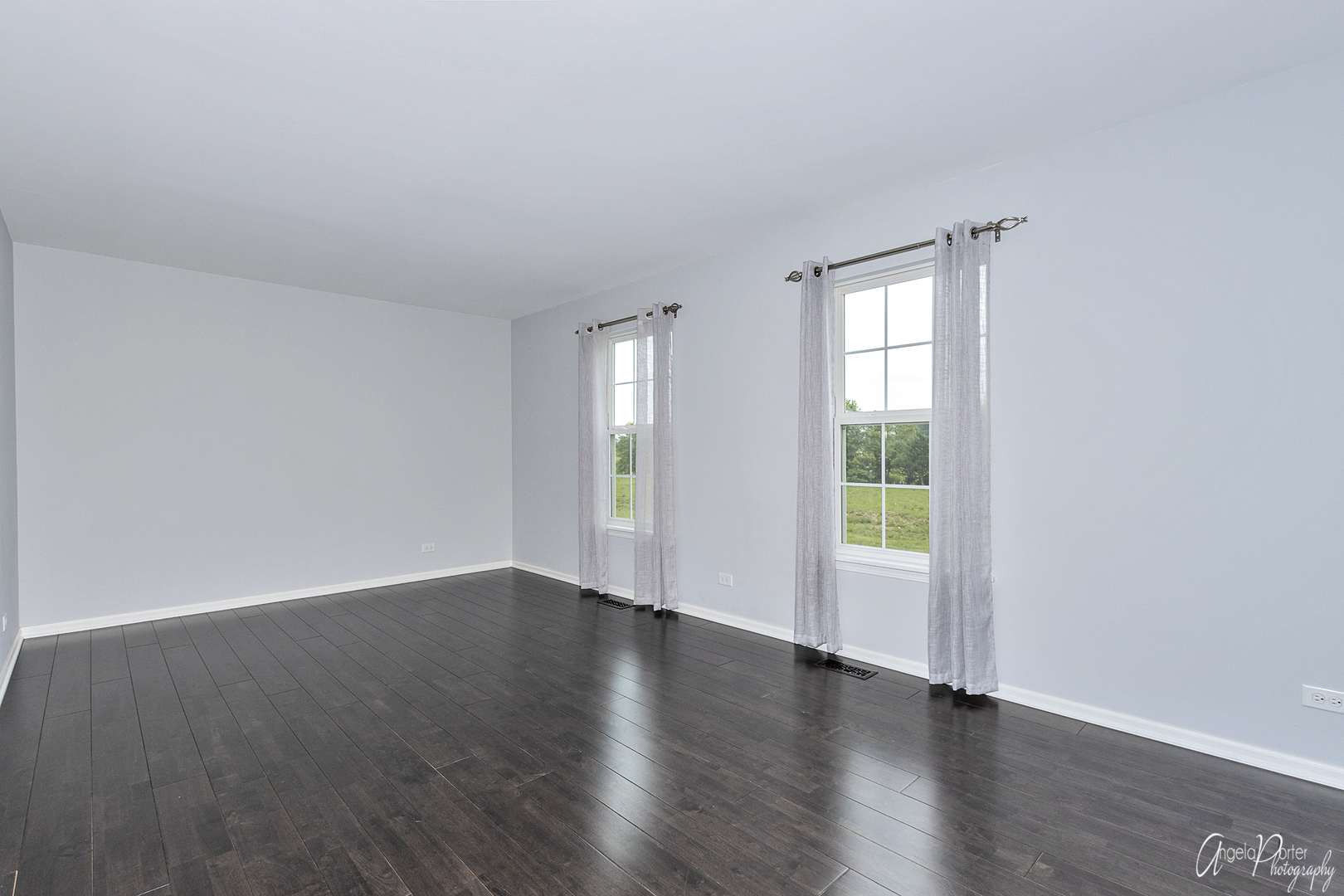 4801 Stillwater Road Wonder Lake, IL 60097 - Photo 24 of 36 an empty room with wooden floor and windows