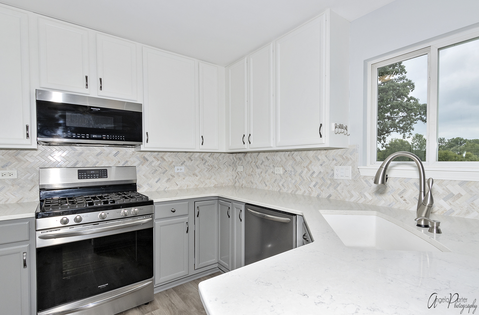 4801 Stillwater Road Wonder Lake, IL 60097 - Photo 5 of 36 a kitchen with granite countertop a stove a sink and a microwave