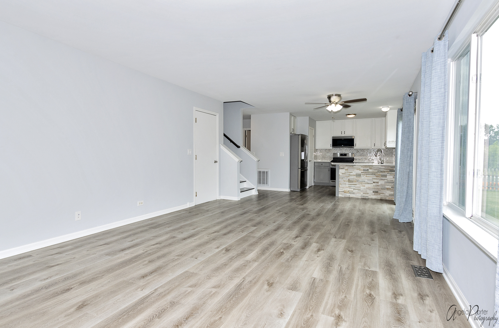 4801 Stillwater Road Wonder Lake, IL 60097 - Photo 9 of 36 a view of a living room hardwood floor and a kitchen