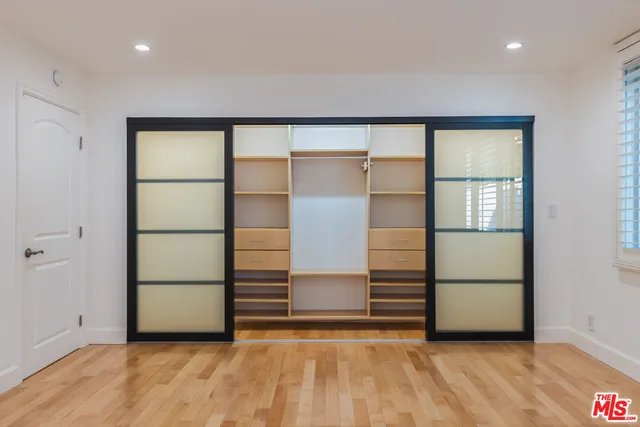 a view of an empty room with a kitchen