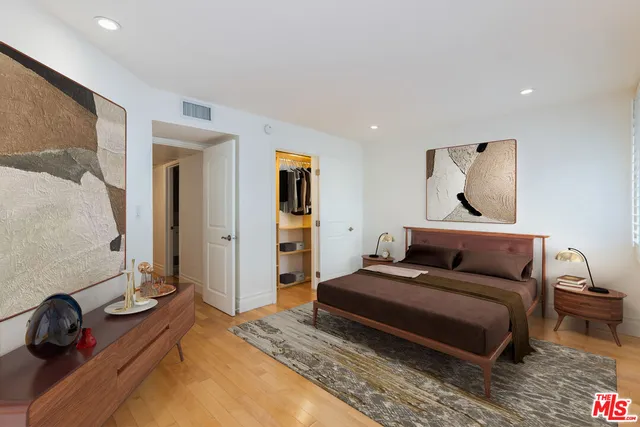 a bedroom with a bed and a couch