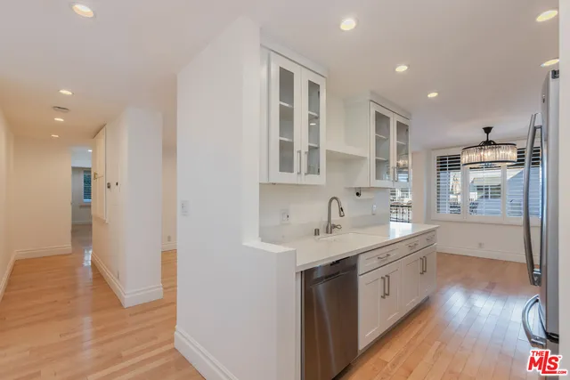 a kitchen with a sink stainless steel appliances and cabinets
