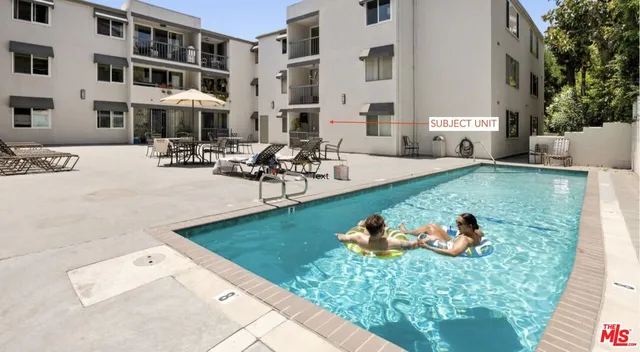 a view of a house with swimming pool and sitting area