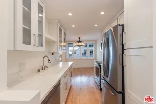 a kitchen with stainless steel appliances a refrigerator and a sink