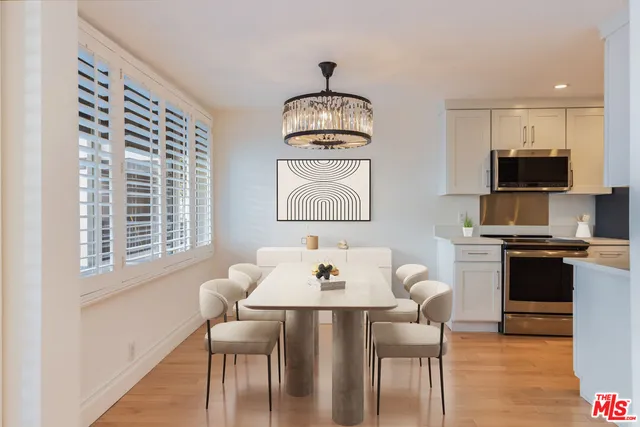 a dining room with furniture a window and wooden floor