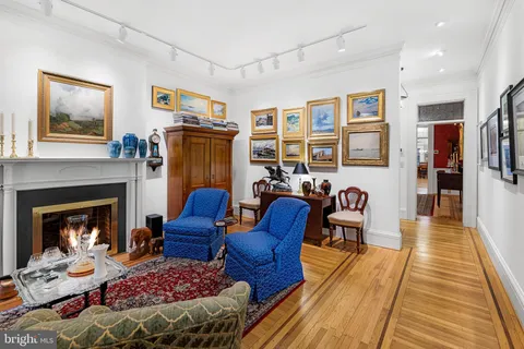a view of a dining room with furniture a chandelier and wooden floor