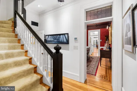 a open kitchen with stainless steel appliances granite countertop a refrigerator a sink dishwasher a stove and a dining table with wooden floor