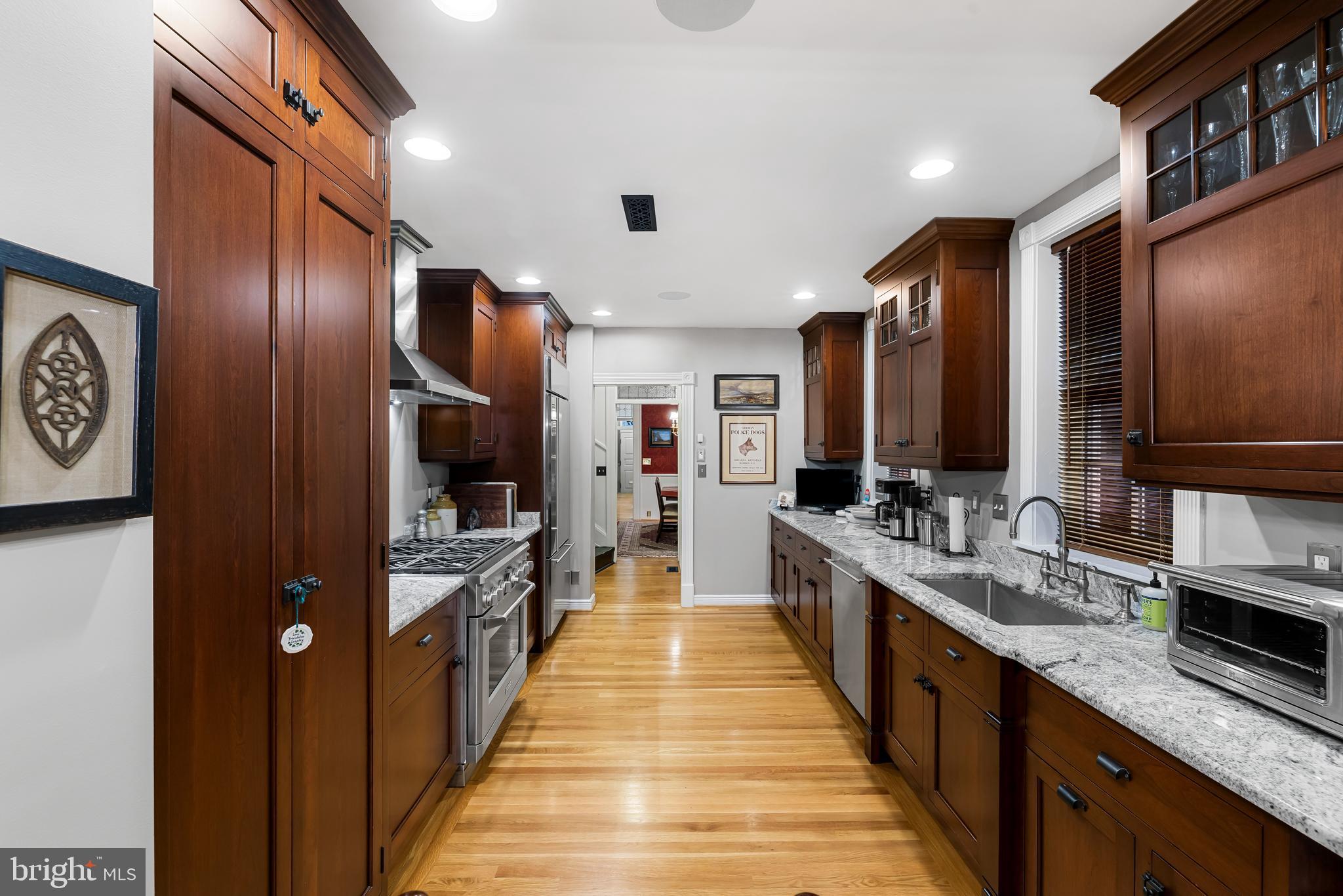 407 Warren Avenue Baltimore, MD 21230 - Photo 27 of 85 a large kitchen with stainless steel appliances a large counter top a stove and a sink
