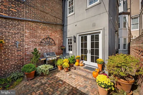 a view of staircase with lots of frames on wall and wooden floor