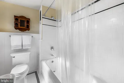 an aerial view of a city with lots of residential buildings ocean and mountain view in back