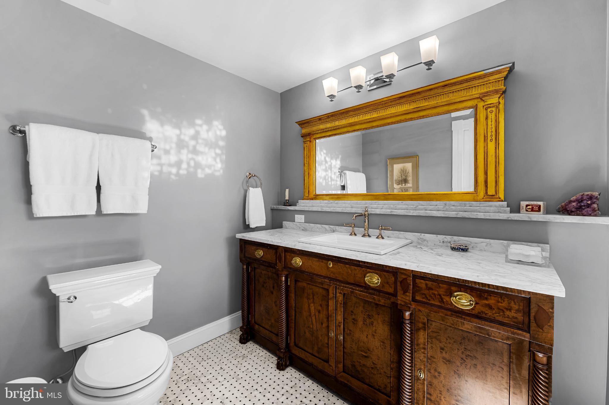 407 Warren Avenue Baltimore, MD 21230 - Photo 56 of 85 a bathroom with a toilet sink and mirror