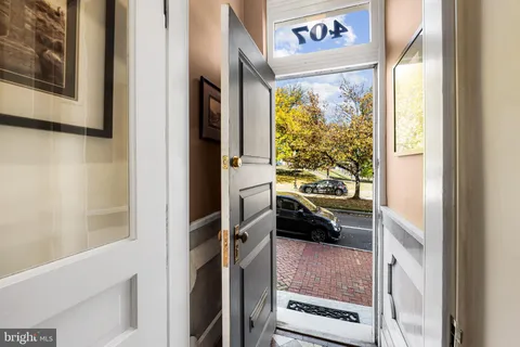 a view of a hallway with furniture and staircase