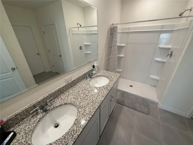 a bedroom with a bed and lamp