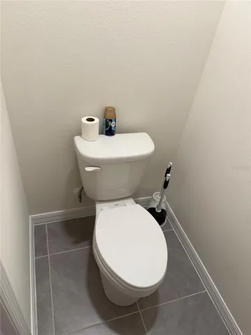 a bedroom with a bed and a chair