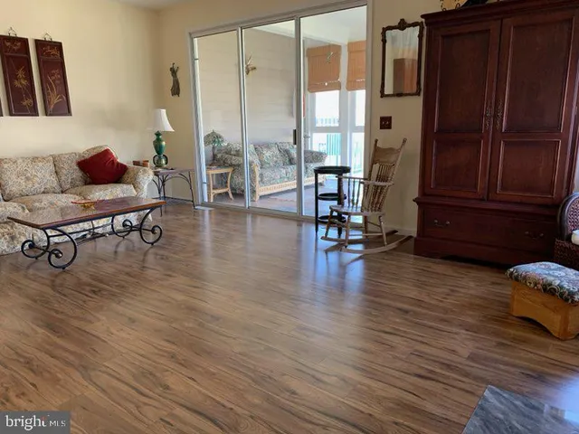 a living room with furniture wooden floor and a table