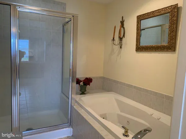 a bathroom with a tub and shower