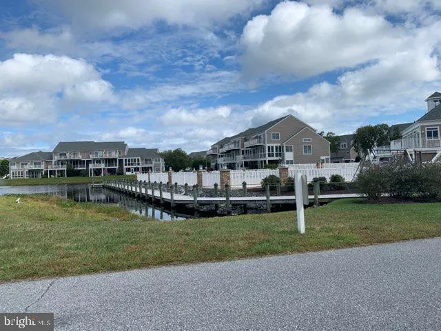 a view of a house next to a lake with a big yard