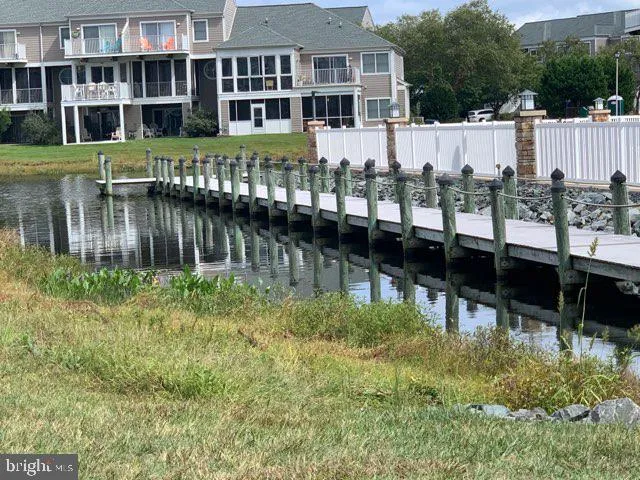 a view of house with a yard and sitting area