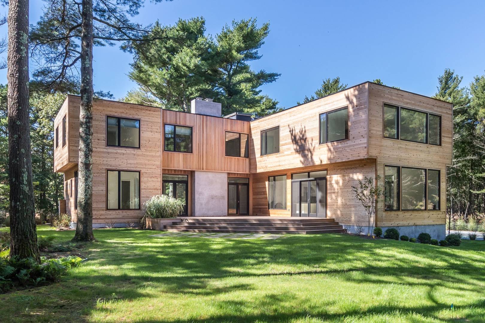 101 2 Holes Water Road East Hampton, NY 11937 - Photo 1 of 27 a front view of a house with a garden