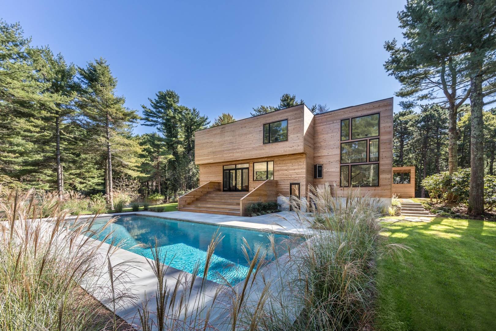 101 2 Holes Water Road East Hampton, NY 11937 - Photo 2 of 27 a view of a house with backyard porch and sitting area