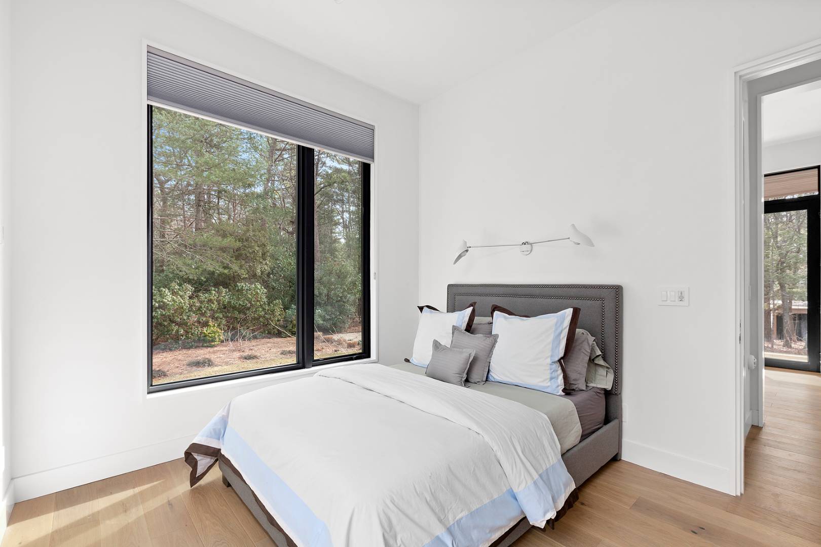 101 2 Holes Water Road East Hampton, NY 11937 - Photo 11 of 27 a bedroom with a bed and a large window