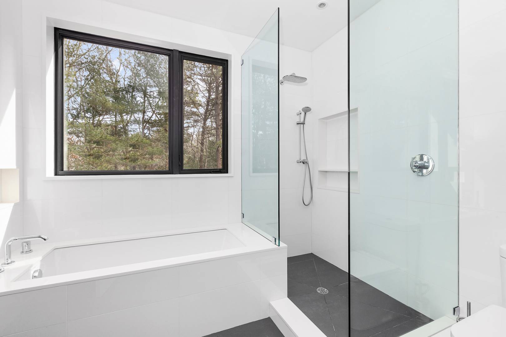 101 2 Holes Water Road East Hampton, NY 11937 - Photo 19 of 27 a bathroom with a bathtub and a shower
