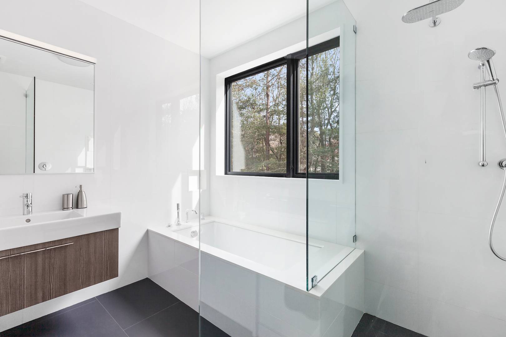 101 2 Holes Water Road East Hampton, NY 11937 - Photo 21 of 27 a bathroom with a sink mirror and a bathtub