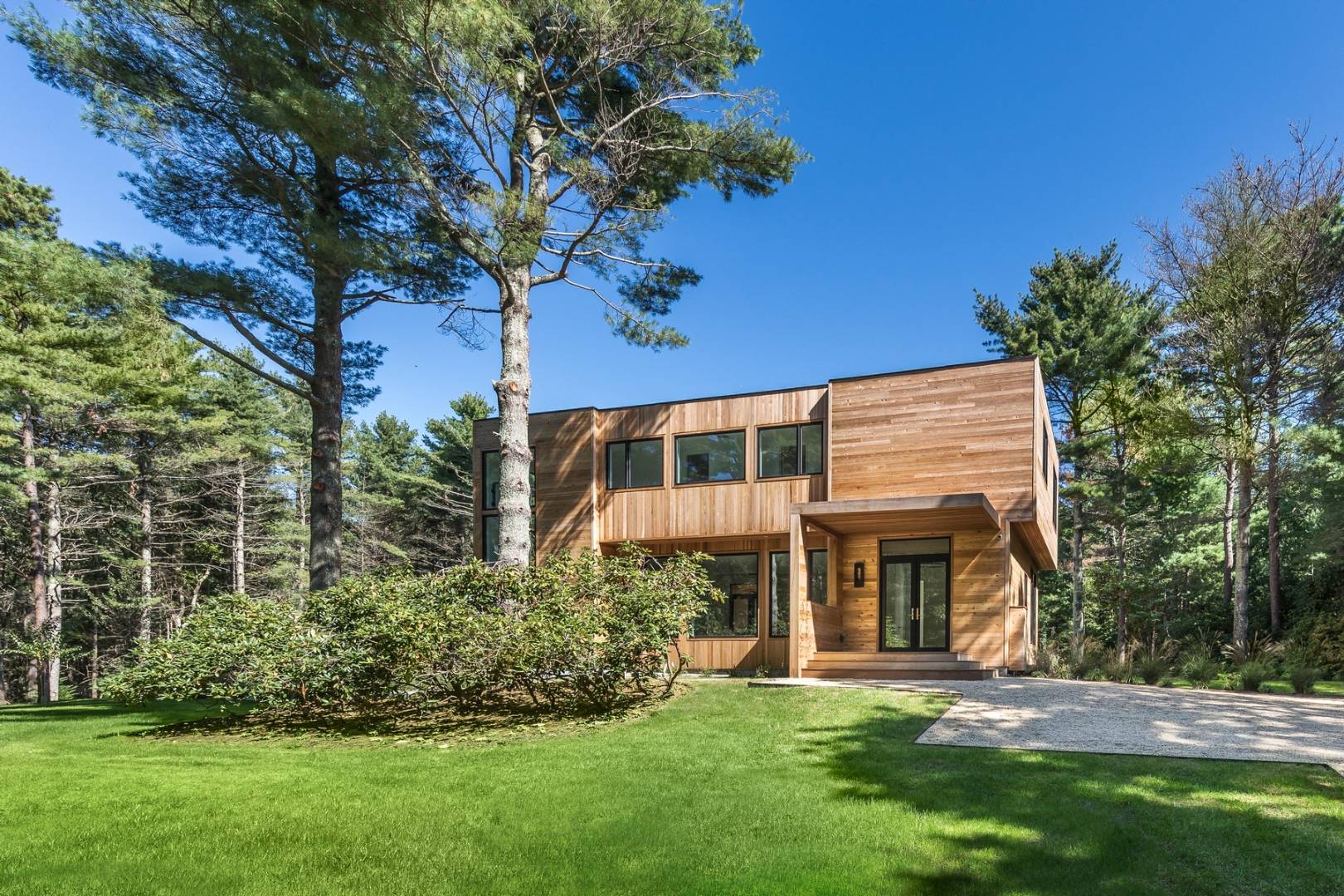 101 2 Holes Water Road East Hampton, NY 11937 - Photo 25 of 27 a front view of a house with a garden