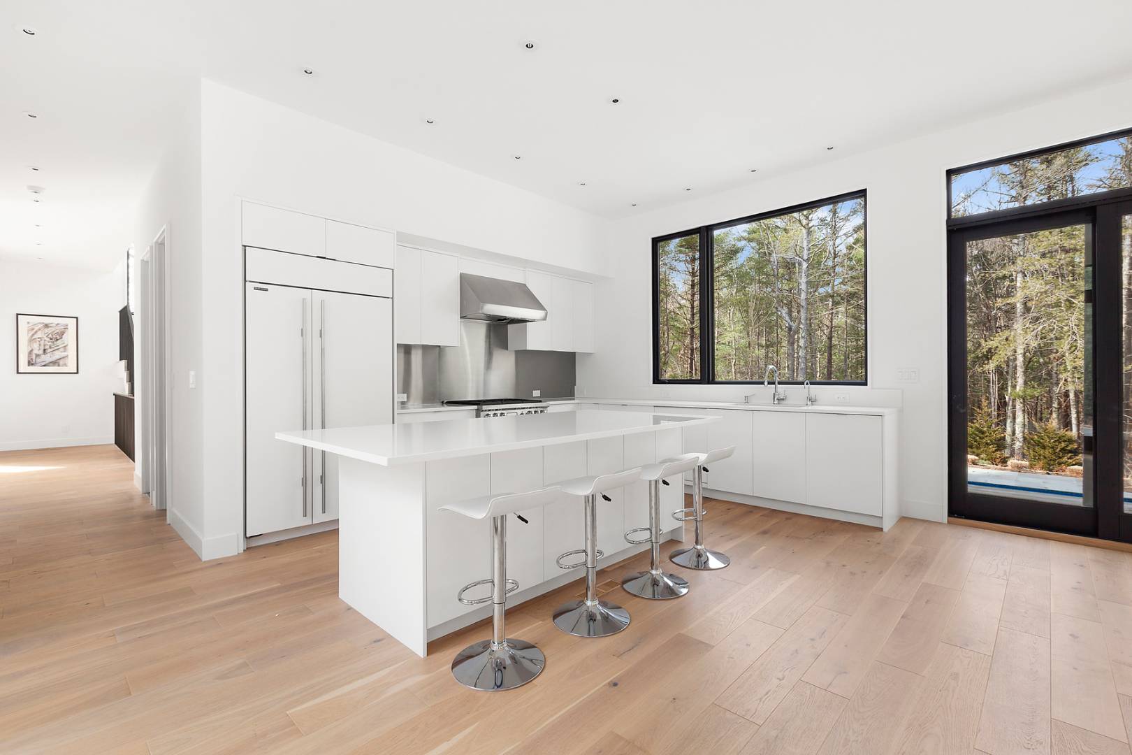 101 2 Holes Water Road East Hampton, NY 11937 - Photo 8 of 27 a kitchen with stainless steel appliances granite countertop a stove a sink and a refrigerator with wooden floors