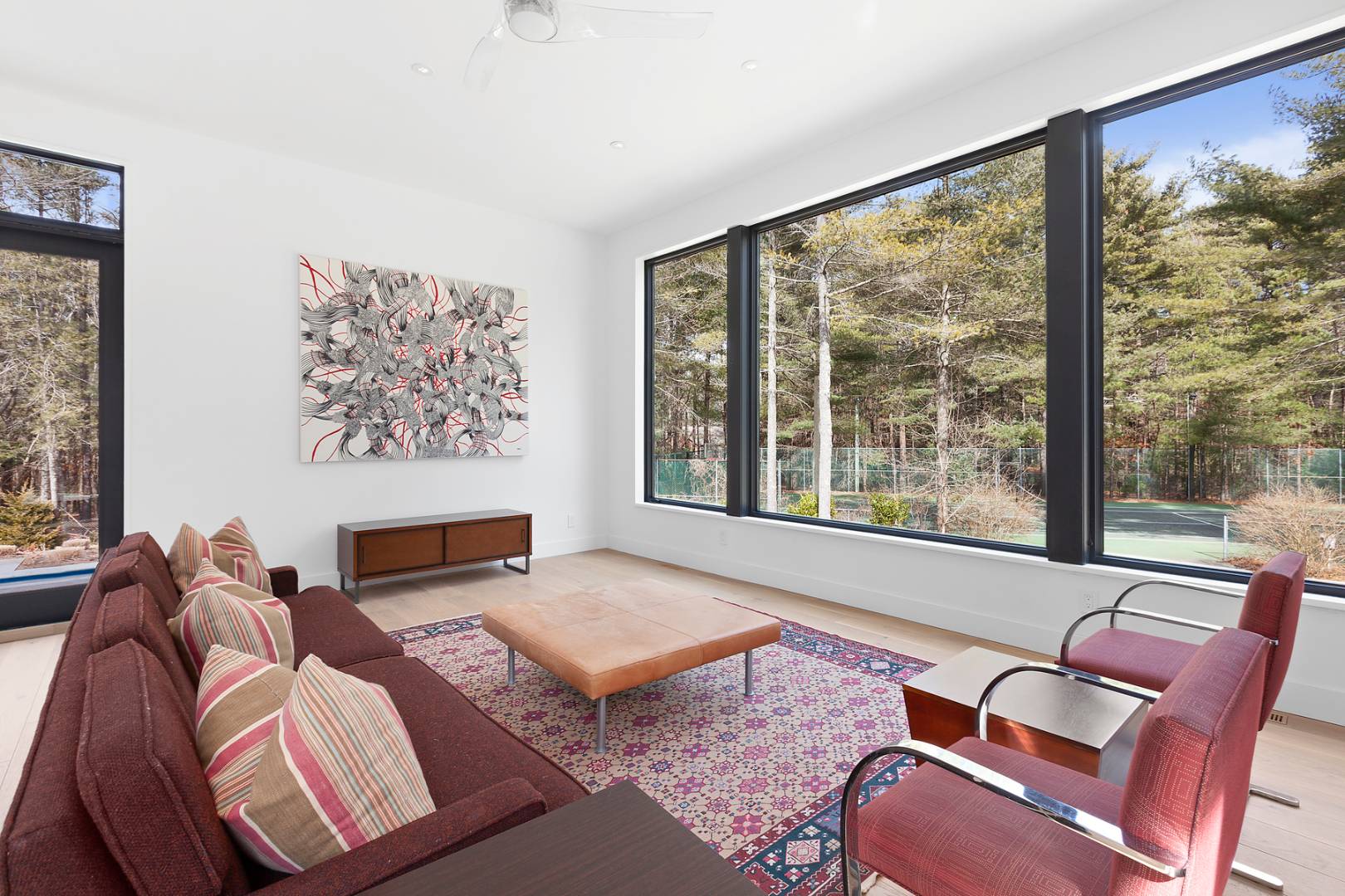 101 2 Holes Water Road East Hampton, NY 11937 - Photo 9 of 27 a living room with furniture and a floor to ceiling window
