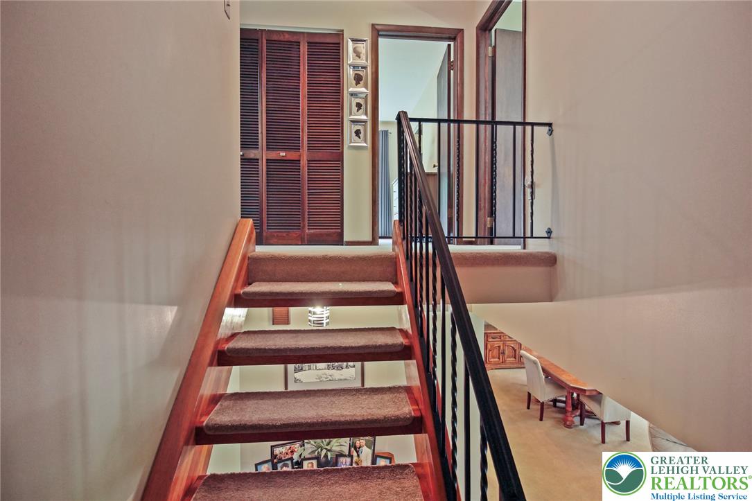 3470 Brodhead Road Bethlehem, PA 18020 - Photo 53 of 84 A split-level landing provides access to various rooms, featuring a mix of carpeted stairs and a wrought iron railing.